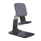 Foldable phone holder stand securely holds a smartphone on a modern desk.
