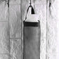 Back view of the waste bag holder, showing the wide handle for easy hanging on a hook.