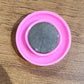 Multiple views of pink board magnet button showing size and colour