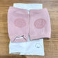 Close-up of knitted pink wool toddler knee warmers with protection