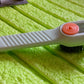 Angled view of the scrubbing brush with dispenser, highlighting its design.