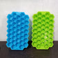 Colorful silicone ice cube tray with honeycomb design for easy release.