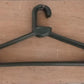 Empty plastic clothes hanger against a plain background, ready for use.