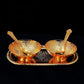 Detailed view of the elegant brass serving set, showcasing its intricate gold and silver plating.