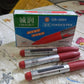 The 10-piece maroon permanent marker set with product details visible.