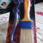 Two basting brushes displayed in a modern kitchen setting.