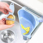 Close-up of the triangular sink drainer shelf's efficient drainage holes.