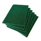 Green cleaning pads effortlessly removing grime from a kitchen tile surface.