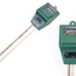 Hand holding the 3-way soil meter, inserting its probe into potted plant soil.