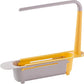 The grey telescopic sink storage rack extended to its maximum length, demonstrating its adaptability.
