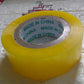 Transparent packing tape roll unwound slightly, showing its strong adhesive side.