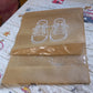 Organivo waterproof shoe bag securely holding sneakers, preventing dirt and moisture transfer.