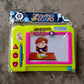 Clean, empty Aditi Magnetic Drawing Board with magnetic pen, ready for drawing.
