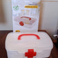 The First Aid Box filled with essential medical supplies like bandages and small bottles.