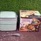 The green stackable tiffin box displayed with its matching spoon.