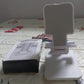 Convenient mobile stand holding a smartphone, shown in a home setting.