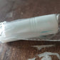 Lifestyle image of a hand holding the lint roller over clothing.