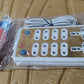 Packaging for the Tetherix 10-way extension board, emphasizing its safety features.