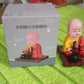 Solar Buddha Statue shown on a car dashboard, enhancing travel ambiance.