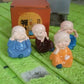 4-piece baby Buddha decorative statues arranged on a shelf