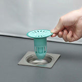 Silicone floor drain stopper preventing hair and odors in a modern bathroom.