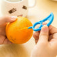 A bright orange being peeled with the Snail Orange Peeler, highlighting its mess-free capability.