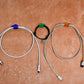 Multiple hand shape wall clips demonstrating their use for organizing small household items.