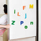 Brightly coloured magnetic letters displayed on a whiteboard, ready for learning.