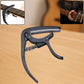 Wagtail Guitar Capo with integrated pick holder on a clean background.