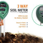 Hand holding the soil moisture tester with pH and light measurement features in a garden.