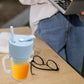 Ergonomic portable juicer with handle, showcasing its 340ml capacity.