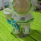 A child holding the lightweight kids astronaut water bottle with its shoulder strap.