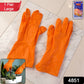 Pair of bright orange dishwashing gloves for household chores