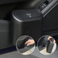 Mini car trash can with auto-rebound lid hanging inside vehicle