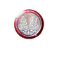 Pooja Coin with packaging displayed on ceremonial cloth