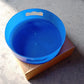 Revolving tray storage unit featuring a convenient brown box.