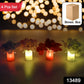 Close-up of a wireless LED decorative light, designed as a vase with silk flowers.