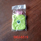 Lifestyle shot of the cute monster hot water bag on a cozy blanket, providing warmth.