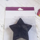 Four colourful star-shaped bath mats in their packaging, ready for use.