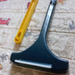 Versatile window cleaning brush being used to clean the mesh on a car window.