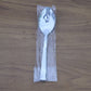 Stacked stainless steel dining spoons placed in a home kitchen setting