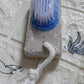 Top-down view of the XcelCraft pumice stone foot scrubber, highlighting its two effective surfaces.