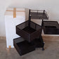 An assembled metal kitchen trolley with wheels, neatly holding various kitchen accessories.