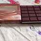 A child's hands writing in the fun chocolate scented bite-shape diary.