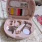 Vertical shot of the Mini Travel Sewing Kit's contents, highlighting threads and tools.