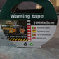 Detailed view of the red and white safety marking tape.