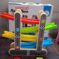Packaging box for the wooden race track toy, showing its contents.
