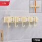 Wall-mounted broom holder securely gripping handles in household utility room