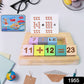 Close-up of Aditi wooden number blocks and arithmetic symbols for early math learning.