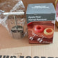 The fruit corer next to a cored apple, showcasing its effectiveness.